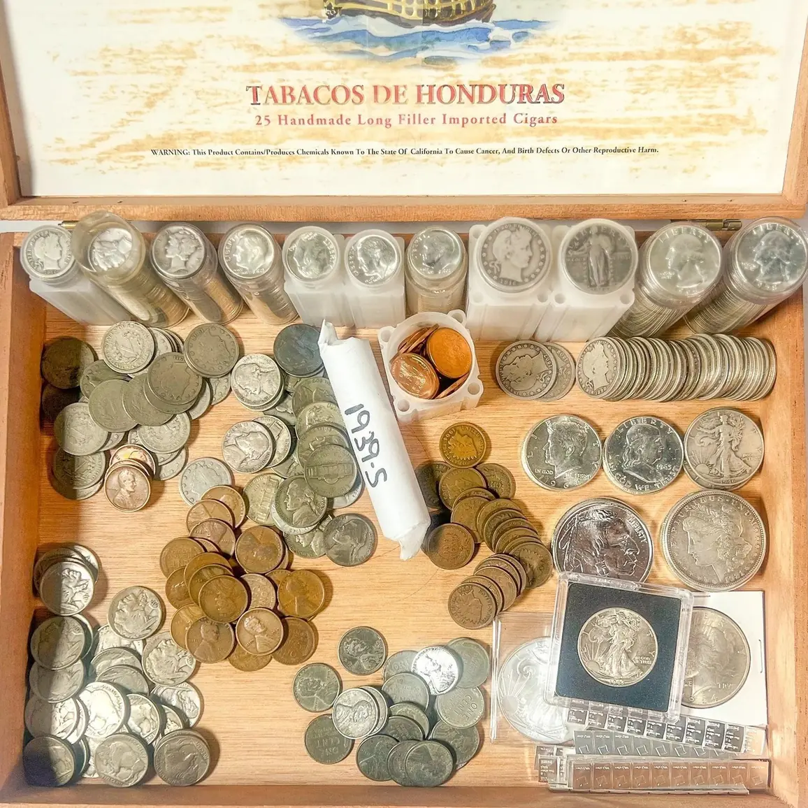 An overview photo of an inherited coin collection laid out on a table