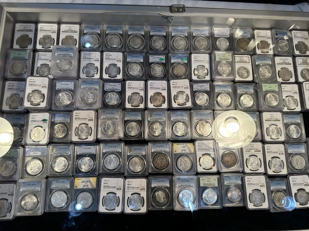 Dealer's case at a coin show filled with PCGS-graded Morgan silver dollars